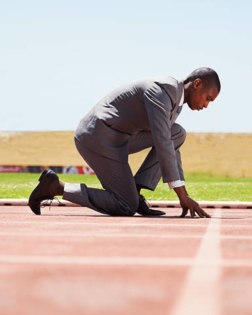 A split image featuring a man in a suit preparing to race on a track and another smiling while seated at a desk, symbolizing ambition and professional achievement.