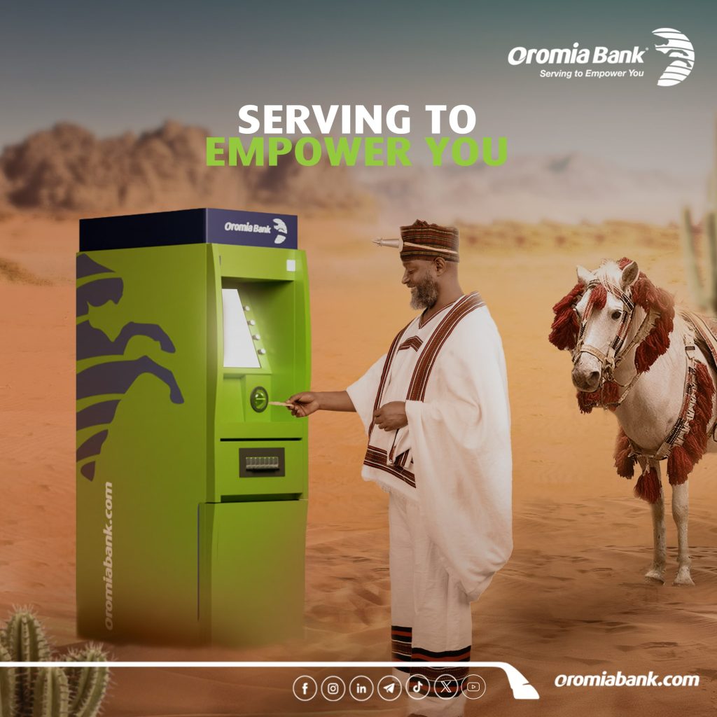 A traditionally oromiya dressed Ethiopian man using an Oromiya International Bank ATM, with a decorated horse beside him, symbolizing modern banking with cultural heritage.