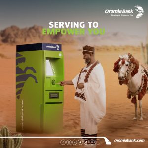 A traditionally oromiya dressed Ethiopian man using an Oromiya International Bank ATM, with a decorated horse beside him, symbolizing modern banking with cultural heritage.